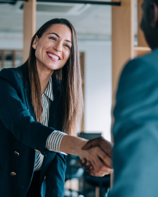 woman shaking a man's hand