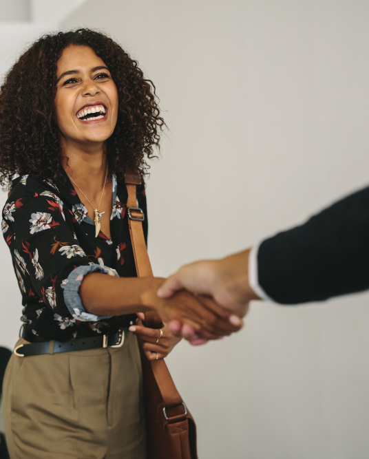 woman shaking a man's hand