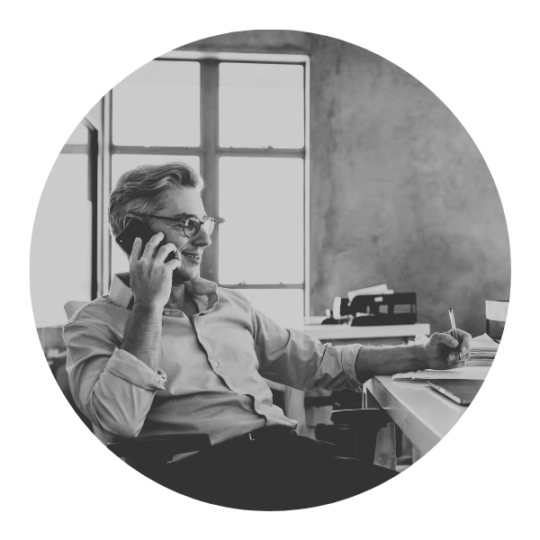 man at desk on phone