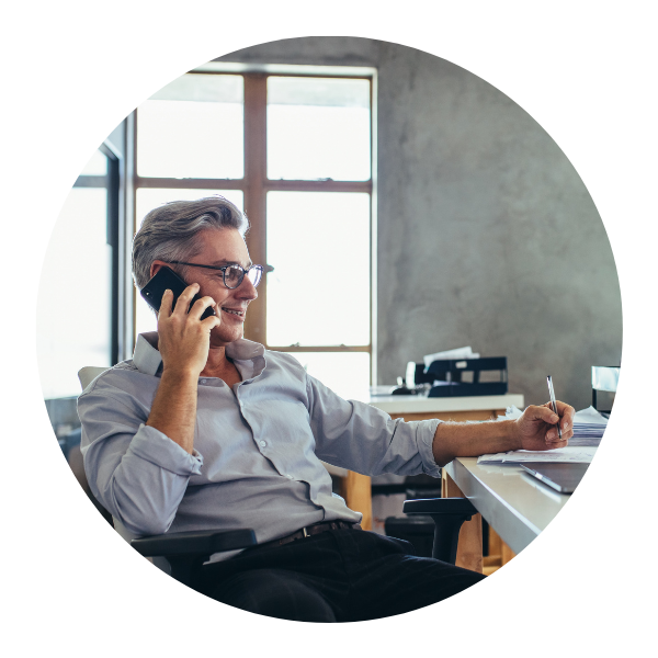 man at desk on phone
